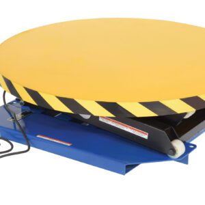 A Vestil Powered Lift Table, 2000# capacity, features a manual carousel with a large round yellow platform with caution stripes. It has a hydraulic scissor design and includes a power cord with a yellow plug on the side.