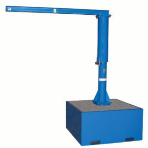 A blue industrial jib crane with a vertical column mounted on the Vestil Additional Steel Base 18 In. Filled W/Concrete has a horizontal boom for lifting and moving heavy objects in workplaces or storage facilities.