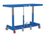 A blue Vestil Ergonomic Long Deck Cart 2K 72 x 30, with a rectangular platform, includes two vertical metal supports, four red wheels, and a foot pedal near adjustable clamps at the base for smooth maneuverability.