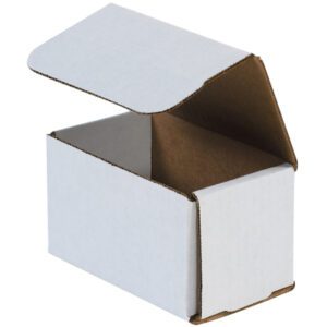 The MH-USA 5 x 3 x 3 White Corrugated Mailer, from a bundle of 50, is a plain white rectangular box with a partially open lid revealing its brown corrugated interior. Angled slightly left, it emphasizes simplicity and sturdy structure.