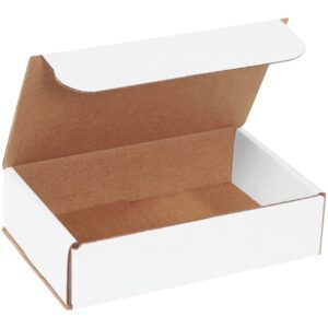 An open MH-USA 8 x 5 x 2 white corrugated mailer shows its brown interior, with a partially lifted lid and sharp edges, rests on a light surface casting a shadow. Ideal for efficient packaging, it is available in bundles of 50.