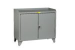 The Little Giant Counter Height Bench Cabinet with Welded Center Shelf is a gray metal unit featuring a flat top, two closed doors, a single handle, small legs, and a warning label above the doors. Its designed for industrial or utility use.