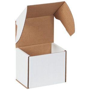 The MH-USA White Outside Tuck Mailers (5 5/8 x 4 3/16 x 5) stand upright with open flaps, showcasing a brown corrugated interior contrasting the smooth exterior. Sold in bundles of 50, theyre ideal for secure and stylish packaging.