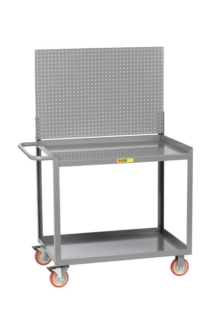The Little Giant Mobile Workstation with Storage Drawer sports a sleek gray metal design, vibrant orange and gray wheels, a perforated pegboard back, a side handle for convenience, two shelves, and is adorned with a caution label for safety.