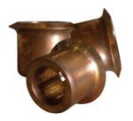 Three cylindrical bronze bushings from a Vestil Drum Deheader are against a white background. With flared ends and a shiny, worn surface, each measures approximately 1.5 X 2 X 2 inches.