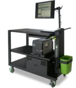 A mobile workstation with green wheels features a computer monitor on an adjustable arm, a keyboard, and other equipment on two shelves. A small green waste bin hangs on the side.