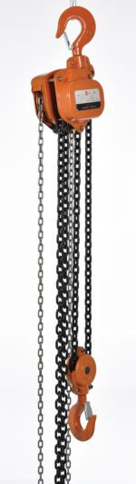 The Vestil Professional Chain Hoist 10K 20 Ft features a vivid orange body, multiple black chains, and top and lower hooks for lifting heavy loads. Its sturdy metallic design includes a small label highlighting its industrial durability.