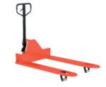 The Vestil Low Profile Pallet Truck 4K 33 X 48 in bright red has a black handle and two sturdy metal forks. Its small wheels excel at maneuvering pallets in warehouses, making it perfect for easily handling heavy loads.