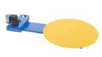 Image of a Vestil Low Profile Powered Carousel 2 In, showcasing a large yellow platform connected to a blue base with an elongated arm and motor.