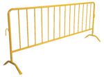 The Vestil Yellow Barrier W/Curved Feet is a stylish crowd control tool with vertical bars and angled legs for stability. It has a hook on one side for easy connection of multiple barriers, against a white background.