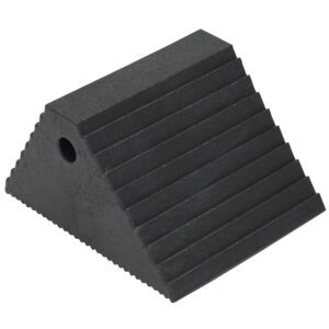 The Vestil Plastic Dual Slope Wheel Chock in black has a triangular design with a textured surface, features horizontal grooves on top, and includes a side circular hole for convenience.