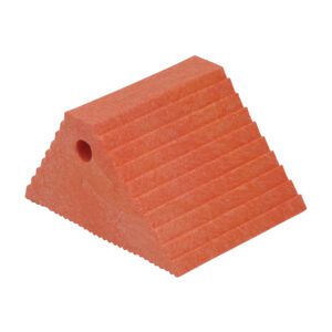 A red, triangular doorstop with horizontal ridges evokes the grip of a Vestil Plastic Dual Slope Wheel Chock Orange. It has a small side hole for easy handling or hanging, and its rubbery surface enhances stability.