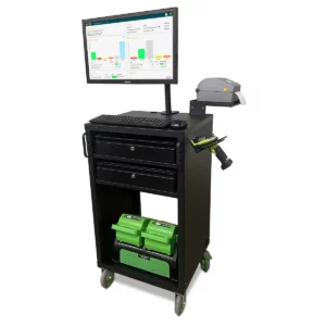 A black mobile workstation with a computer monitor displaying graphs, a keyboard, a barcode scanner, and two drawers. Below, there are green storage bins on a shelf. The station is on wheels for easy mobility.