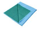 A folded blanket with a blue exterior and green interior displays a zigzag quilted design, reflecting the style and durability of Vestil Heavy Duty Moving Pads in a premium polyester/cotton blend.