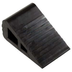 The Vestil Industrial Rubber Wedge 6.5 X 4 is a black rubber chock with a ribbed, wedge shape designed for stability and movement prevention, featuring hollow sections for lighter weight and easy handling.