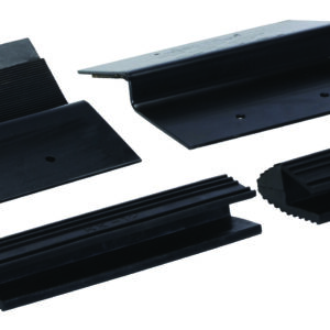 Four black rubber chocks with varying shapes are displayed on a white background. Designed to stabilize vehicles, they are angled and ribbed with mounting holes. These chocks complement the versatility of the Vestil Wooden Ramp Kit 12 X 2 In.