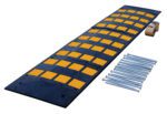 The Vestil Rubber Speed Hump 23.5 X 108 Asphalt offers black segments with yellow accents, two metal plates for installation, a roll of brown tape, and sturdy metal spikes or bolts, making it ideal for effective traffic control on asphalt surfaces.