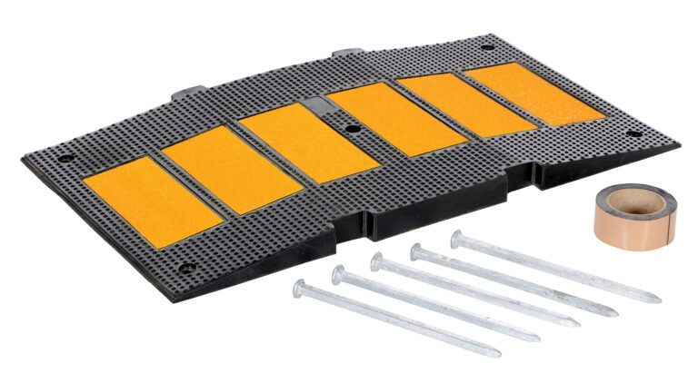 The Vestil Middle Section Asphalt Kit 35.25 includes a black rubber speed bump with five yellow reflective strips, adhesive tape, and five long metal screws for easy installation, enhancing safety and visibility on roadways.