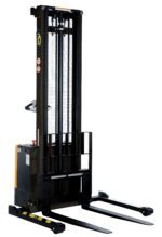 The Vestil Adjust Powered Lift Stacker 150In Raised is an electric pallet stacker with a 150-inch mast, two base forks, a control handle, and safety labels. Primarily black with yellow accents, its ideal for lifting and transporting pallets in warehouses.