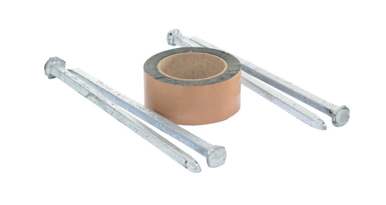 An adhesive tape roll sits beside four long nails, similar to the Vestil Asphalt Kit for Speed Bumps with 4 Holes, all on a white background.