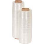 Two rolls of MH-USA 17.2 x 38 gauge pre-stretch wrap with brown cores are upright. The shiny, translucent wrap is perfect for packaging or wrapping tasks, similar to the products full specification: 1,500 Pre-Stretch Wrap (4 Rolls/Case).