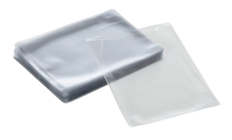 A stack of clear, rectangular plastic laminating pouches, with one pouch slightly open, sits elegantly against a white background, echoing the sleek design of Vestil Standard Shop Ticket Holders.