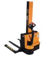 The Vestil Stacker Narrow Mast Pwr Drive Adj 62 In features a narrow mast and power drive in classic orange and black. This electric unit has a long steering handle, adjustable 62-inch horizontal forks for pallet lifting, and safety labels on its vertical section.