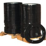Two large stacks of MH-USA 3/4 x .020 Gauge x 1,960 High-Tensile Steel Strapping (100Lbs/Coil) are placed on wooden pallets. One coil is positioned upright in front, displaying its circular form. The shiny strapping appears uniform and weighs 100 lbs per coil.