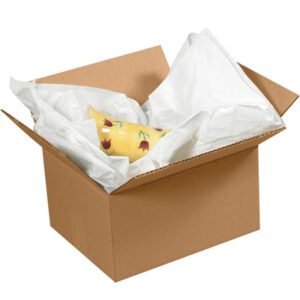 An open cardboard box reveals a yellow ceramic vase wrapped in MH-USA 24 x 36 Economy Tissue Paper (2880/Case). The open flaps showcase the vibrant red floral design of the vase nestled in white wrap.