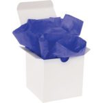 A white gift box with an open lid is filled with MH-USA 15 x 20 Parade Blue Gift Grade Tissue Paper (960 Sheets), adding elegance.
