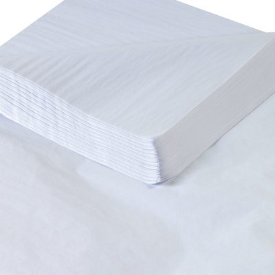 T1824J.jpg A close-up image captures a neatly stacked pile of MH-USA 18 x 24 White Gift Grade Tissue Paper (960 Sheets) on a flat surface, with clean, crisp sheets highlighting the texture and uniformity.