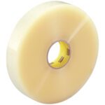 A large roll of 2 x 1000 yds. Clear 3M™ 311+ Carton Sealing Tape with a yellow core is shown on a white background. Glossy and translucent, it’s ideal for sealing packages and boxes, available in a set of six rolls per case.