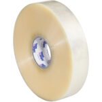 A case contains six rolls of 2 x 1000 yds. Clear Tape Logic® Lbs700 Economy Tape, with a white core and blue text. The tape has a smooth, glossy, slightly reflective surface.