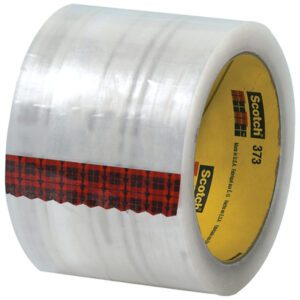 The 3 x 55 yds. Clear 3M - 373 Carton Sealing Tape (6 Pack) features a red plaid strip and an inner core with Scotch 373 and logo, offering reliable packaging solutions for all your carton sealing needs.