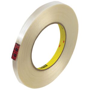 The 1/2 x 60 yds. Scotch® Filament Tape 890MSR, sold in cases of 72 rolls, features a clear adhesive with a yellow core and small red plaid pattern near the core.