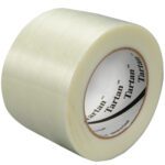 The 3 x 60 yds. Tartan™ Filament Tape 8934 offers a clear, ridged surface with a white core labeled Tartan. Available in a convenient 6-pack, this strong tape is set against a plain white background.