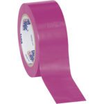 A roll of bright purple adhesive tape, partially unrolled, lies next to its counterparts in a 2 x 36 yds. Purple (3 Pack) Tape Logic® Solid Vinyl Safety Tape. The glossy tapes inner core features blue and white branding on a plain white background.