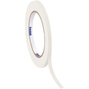 A 1/4 x 60 yds. White Tape Logic® Masking Tape roll is partially unwound, showing blue text inside. The slender tape stands upright against a white background, highlighting its crisp appearance.