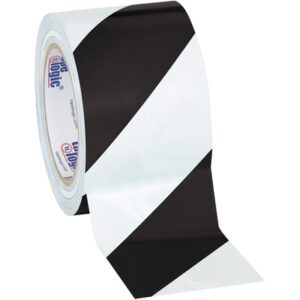 The Tape Logic® Striped Vinyl Safety Tape, 3 x 36 yds., featuring a black and white diagonal pattern, is unrolled against a plain backdrop. Available in Black/White (3 Pack), its an essential tool for versatile use.