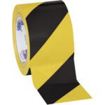 The 3 x 36 yds. Black/Yellow Tape Logic® Striped Vinyl Safety Tape (16/Case) features a vibrant yellow and black diagonal stripe pattern, ideal for enhancing visibility and safety.