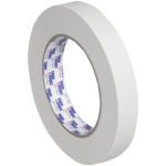 A roll of 3/4 x 60 yds. Tape Logic® 2600 Masking Tape from a case of 48 is seen upright on an invisible surface against a pristine white background, with its logo on the inner core visible.