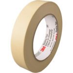 A beige roll of 1 x 60 yds. 3M™ 203 masking tape with a white inner core and red/black text on the label, highlighting the brand name, is displayed vertically to emphasize its width and thickness. Sold in cases of 36 rolls.