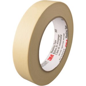 A beige roll of 1 x 60 yds. 3M™ 203 masking tape with a white inner core and red/black text on the label, highlighting the brand name, is displayed vertically to emphasize its width and thickness. Sold in cases of 36 rolls.