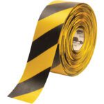The 4 x 100 Yellow/Black Mighty Line™ Deluxe Safety Tape roll, with bold diagonal stripes, is ideal for marking hazardous areas or caution zones. This high-quality tape is partially unrolled, revealing its striking design.