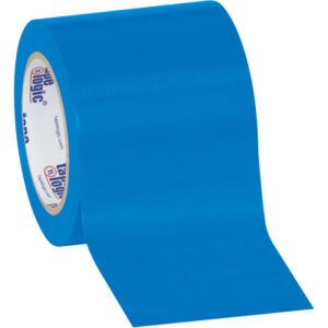 A partially unrolled 4 x 36 yds. Blue Tape Logic® Solid Vinyl Safety Tape (12 Rolls/Case) displays its smooth, glossy surface and inner text on a cardboard circle, lying on a plain white background, showcasing functionality and visibility.