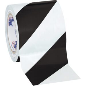 The 4 x 36 yds. Black/White Tape Logic® Striped Vinyl Safety Tape, available in a case of 12 rolls, features alternating black and white diagonal stripes, perfect for marking hazardous areas effectively.