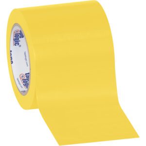 Partially unrolled, a wide bright yellow roll of 4 x 36 yds. Tape Logic® Solid Vinyl Safety Tape with a shiny surface and an inner core printed in blue text on white comes in cases containing 12 rolls.