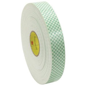 The 1/2 x 36 yds. (1 Pack) 3M™ 4016 Double Sided Foam Tape boasts a thick, green checkered adhesive and a neatly coiled, circular shape with a central label.