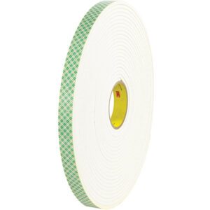 A roll of 1 x 18 yds. 3M Double Sided Foam Tape 4004, part of a versatile set of 9/Case, stands upright against a plain background. The tape is white with a green checkered edge and features a yellow core with the red 3M logo.