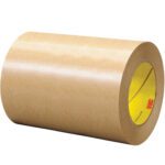 The 6 x 60 yds. (1 Pack) 3M™ 465 Adhesive Transfer Tape Hand Roll has a glossy brown surface and yellow core, displaying the 3M logo inside for quality assurance.